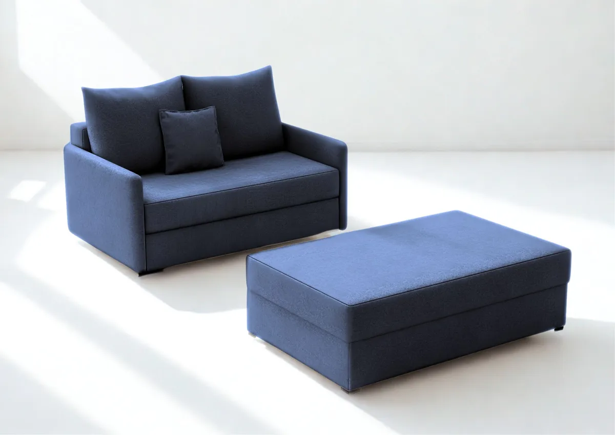Sofa granatowa ARKADIA z funkcją spania z pufą 130 cm: Granatowa sofa ARKADIA